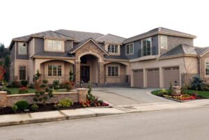 A spacious living room with large windows, natural wood finishes, soft neutral furnishings, and integrated lighting.