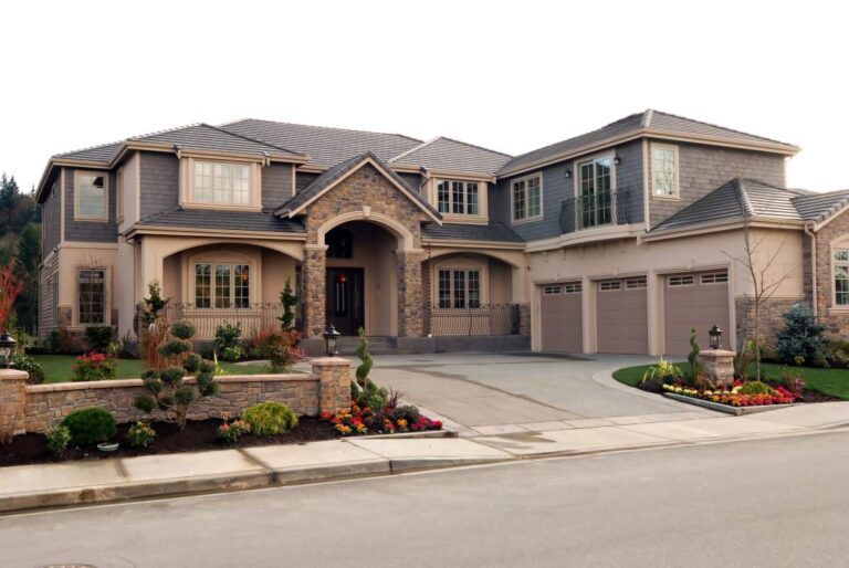 A spacious living room with large windows, natural wood finishes, soft neutral furnishings, and integrated lighting.